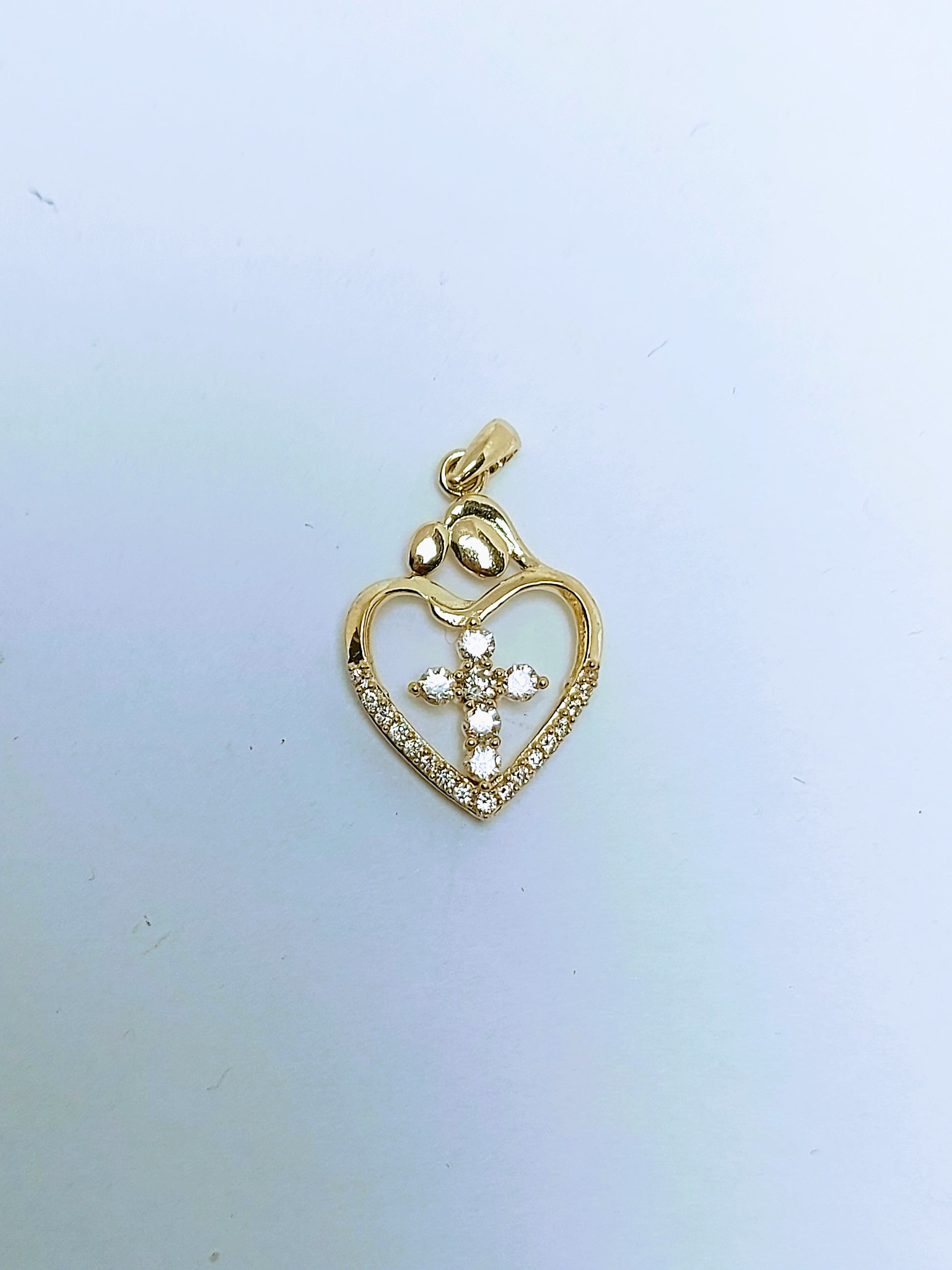 Heart with cross inside gold pendant