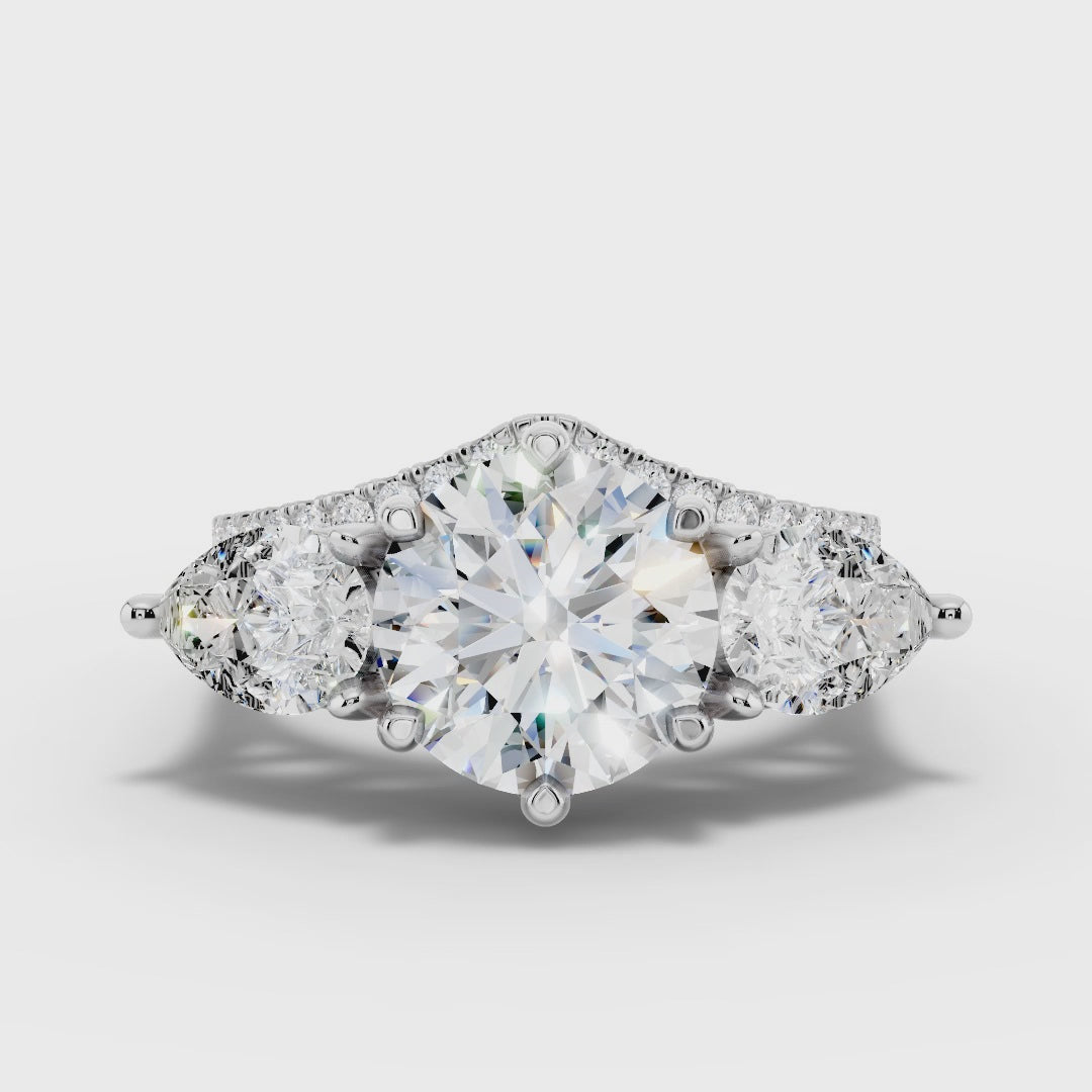 Three stone Ring with Pear shape sides and matching wedding ring.